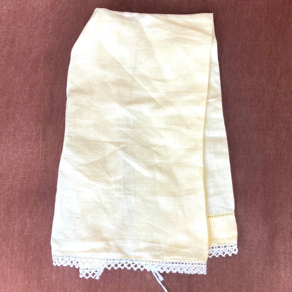 One fine linen embroidered tea towel. A muted butter yellow Vintage 1960s